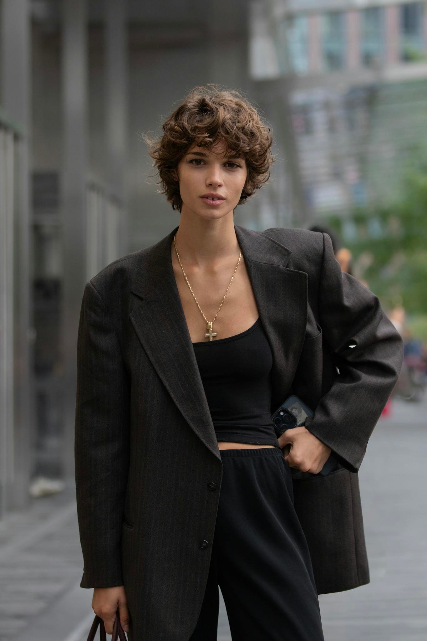 A young woman exemplifies urban chic fashion with modern elegance in New York City.